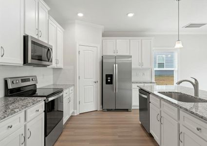 Kitchen with white cabinets and stainless appliances.