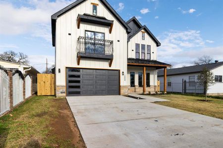 Modern inspired farmhouse featuring a balcony, a front lawn, and a garage