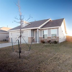 View of front facade featuring a garage and a front yard