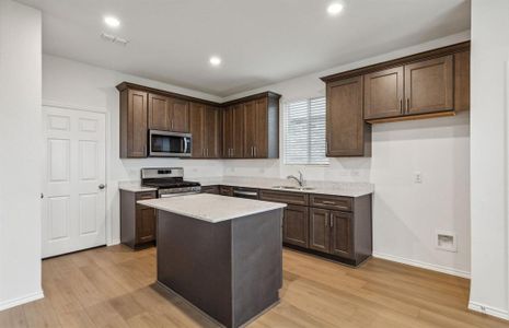 Spacious kitchen with oversized island *real home pictured