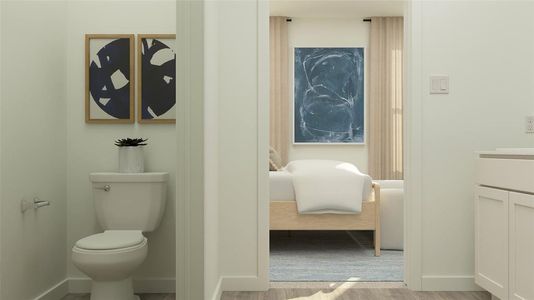 Bathroom featuring hardwood / wood-style floors, vanity, and toilet