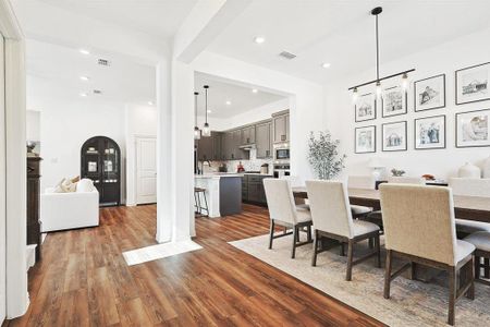 Dining space with dark hardwood / wood-style floors