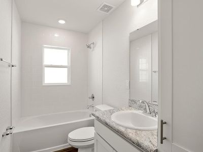 Secondary bedrooms share a convenience hall bath with linen cabinets.