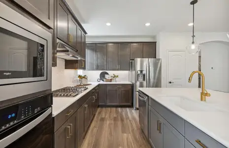 Abundant cabinet space and pendant lighting in kitchen *Photos of furnished model. Not actual home. Representative of floor
plan. Some options and features may vary.