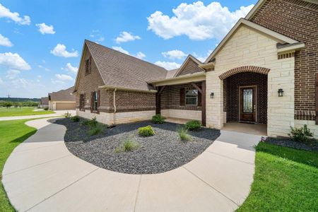 View of front of house with a garage and a front lawn