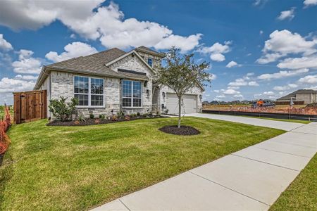 Craftsman-style house featuring a garage and a front yard