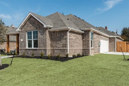 View of home's exterior featuring a garage and a yard