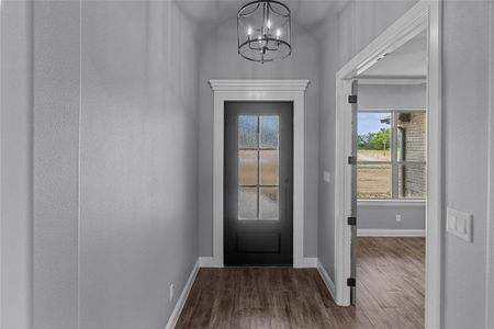 Entryway with a chandelier and hardwood / wood-style floors