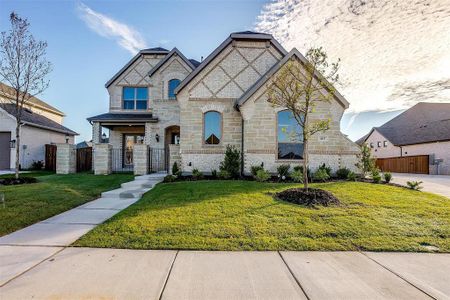 French country inspired facade featuring a front lawn