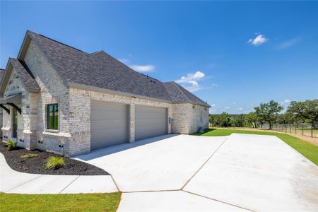 View of property exterior with a yard and a garage