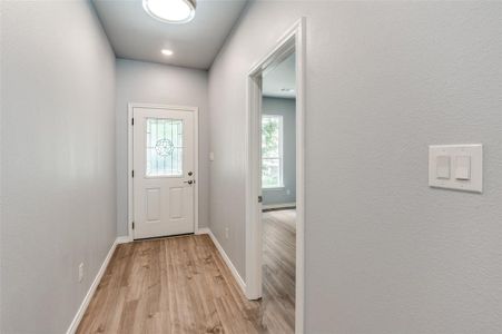 Doorway to outside featuring light hardwood / wood-style floors