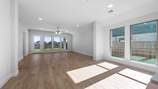 Unfurnished living room featuring light hardwood / wood-style flooring and ceiling fan