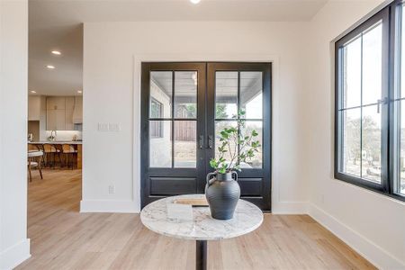 Entrance foyer with recessed lighting, french doors, baseboards, and light wood finished floors