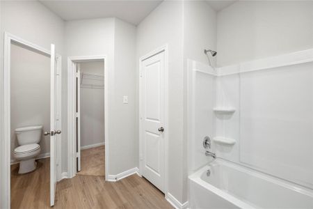 The primary bathroom has tons of room with a walk-in closet and plenty of storage space.