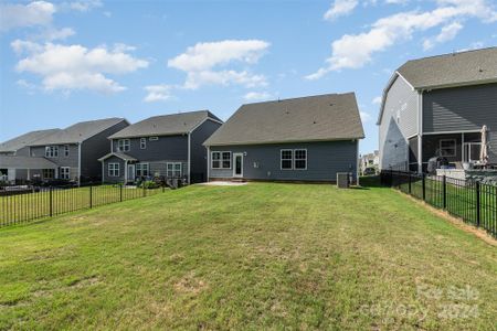 Back of house with flat backyard