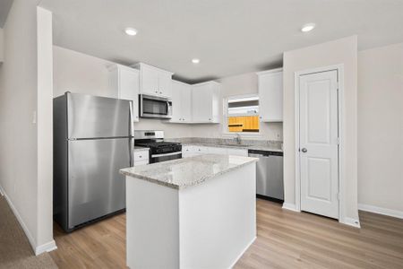 Stainless Steel appliances along with a breakfast bar.