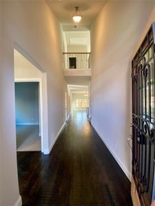 Elegant entry with cathedral ceiling, Juliet balcony with wrought iron spindles, and rich handscraped hardwood floors.