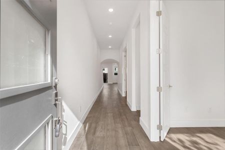 Hall with light hardwood / wood-style flooring