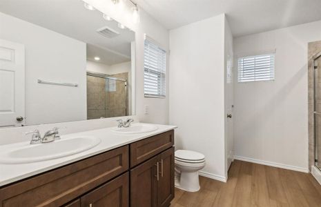 Spacious owner's suite with dual vanity *real home pictured