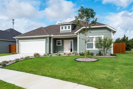 View of front of home with a garage and a front yard