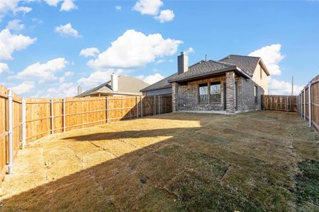 Rear view of house featuring a lawn and a patio area