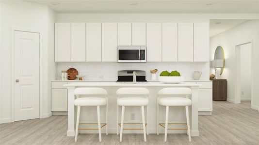 Kitchen with light hardwood / wood-style floors, stove, white cabinetry, and tasteful backsplash