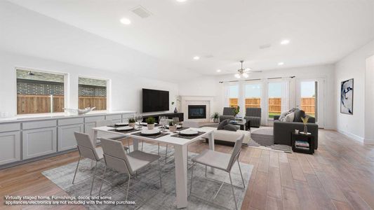 Dining space with ceiling fan and light hardwood / wood-style floors