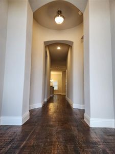 Corridor with dark hardwood / wood-style flooring