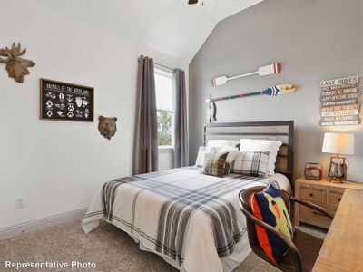 Bedroom with carpet and lofted ceiling