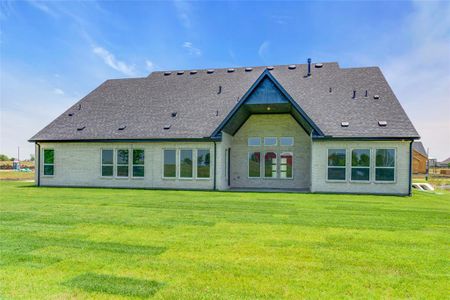 Back of house featuring a lawn