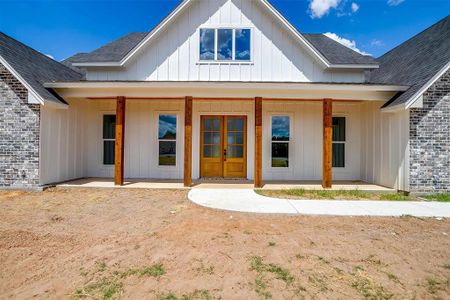 Back of house featuring a porch