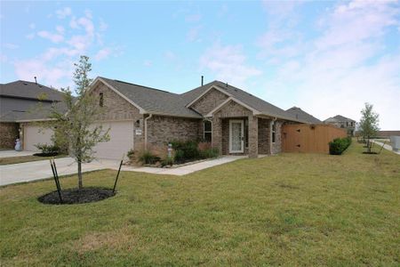 Charming single-story brick home with a two-car garage, well-maintained front lawn, and a welcoming entrance. Features a secure wooden side gate and tasteful landscaping.