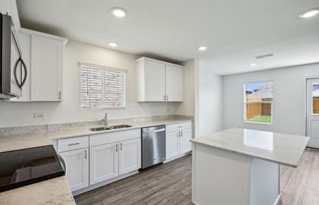 Ample cabinet space with upgraded appliances *real home pictured