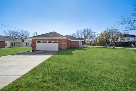 View of property exterior with a lawn and a garage