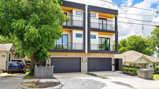 View of front of home featuring a garage and a balcony