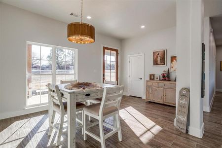 Dining space with dark wood-type flooring