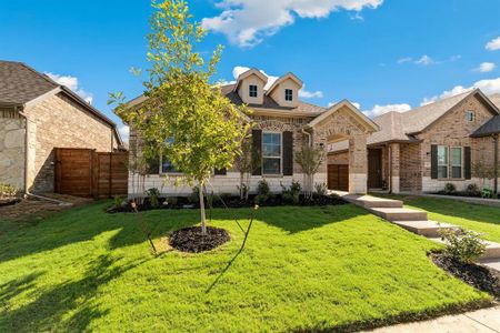 View of front of property featuring a garage and a front yard