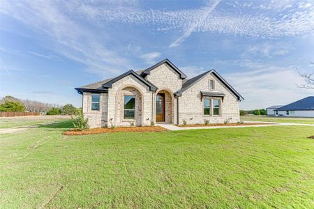 French country style house featuring a front lawn