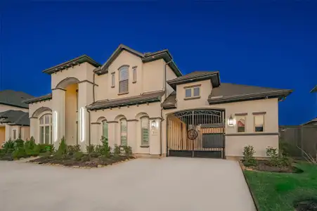 From the moment you arrive, you are greeted by a stunning full-stucco exterior in a rare and rich neutral palette, perfectly complemented by a gracefully curved driveway. The double-door porch entryway invites you into a world of sophistication and style.