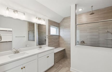 Spacious owner's bathroom with dual vanity and large shower *real home pictured