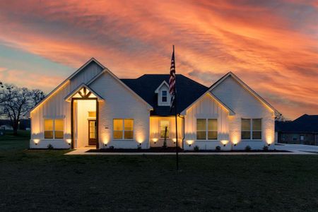 Modern inspired farmhouse featuring a lawn