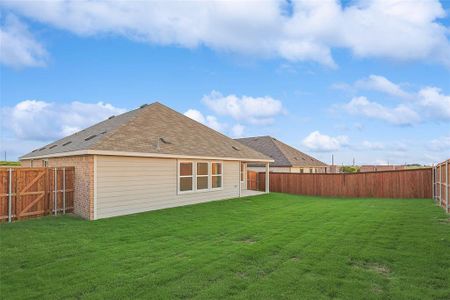 Rear view of property featuring a yard