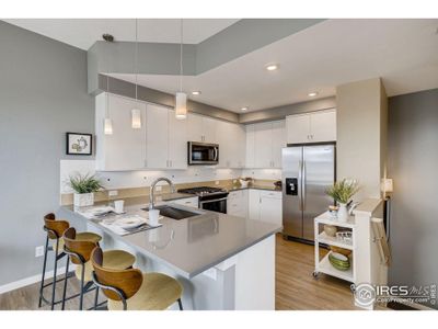 Quartz countertops with fill tile backsplash. Photos are of the model home.