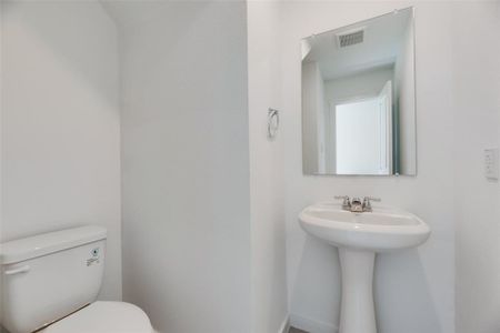 Bathroom featuring sink and toilet