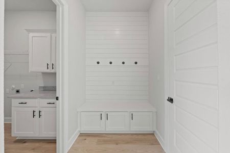 Mudroom and laundry room are conveniently adjacent as you enter from the garage.