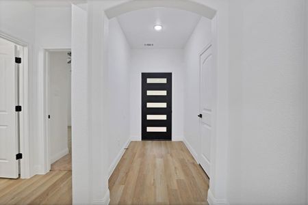 Doorway with light wood-type flooring