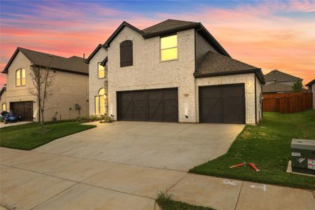 French country home featuring a yard and a garage