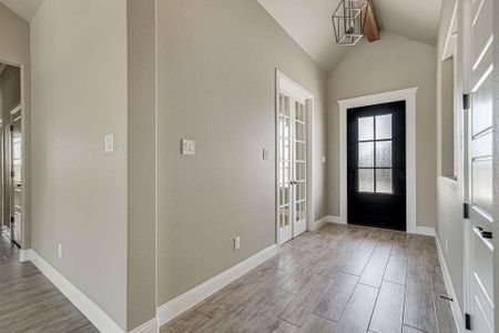 Foyer featuring light hardwood / wood-style flooring and vaulted ceiling