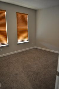 Spare room with dark colored carpet