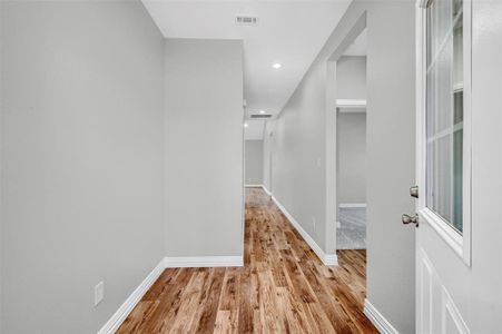 Corridor featuring light wood-type flooring